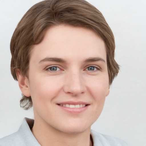 Joyful white young-adult female with short  brown hair and grey eyes