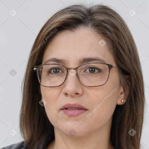 Joyful white adult female with long  brown hair and brown eyes