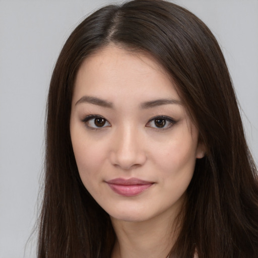 Joyful asian young-adult female with long  brown hair and brown eyes