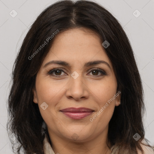 Joyful latino adult female with medium  brown hair and brown eyes