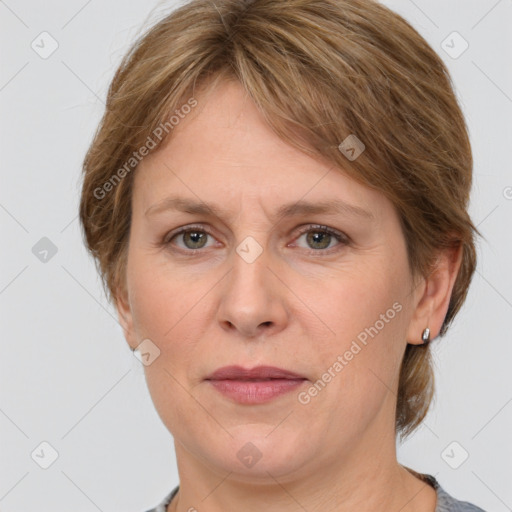 Joyful white adult female with medium  brown hair and grey eyes