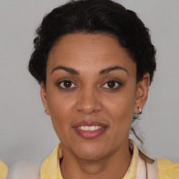 Joyful latino young-adult female with short  brown hair and brown eyes
