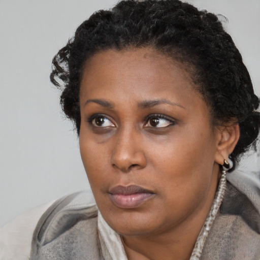 Neutral black young-adult female with short  brown hair and brown eyes
