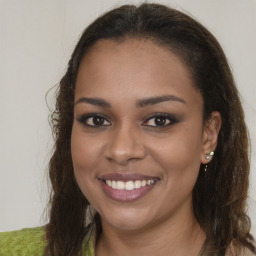 Joyful black young-adult female with long  brown hair and brown eyes
