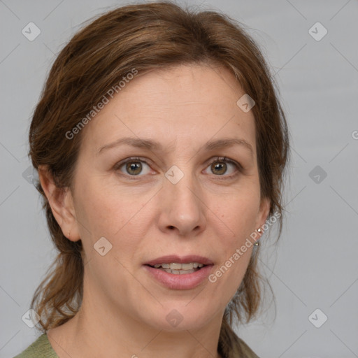 Joyful white adult female with medium  brown hair and blue eyes