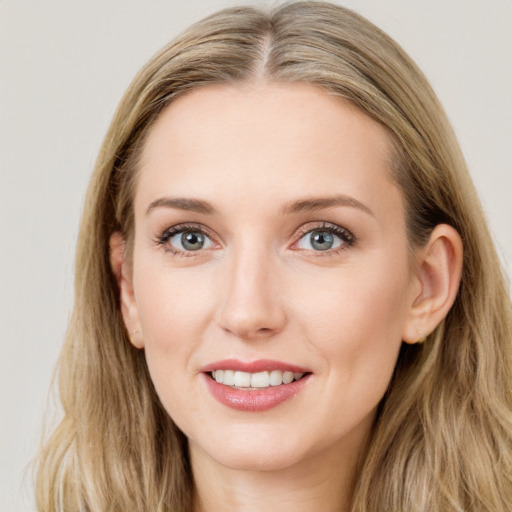 Joyful white young-adult female with long  brown hair and blue eyes