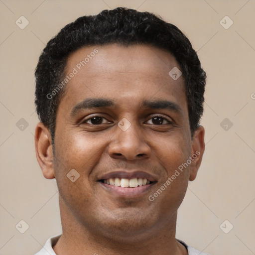 Joyful latino young-adult male with short  brown hair and brown eyes