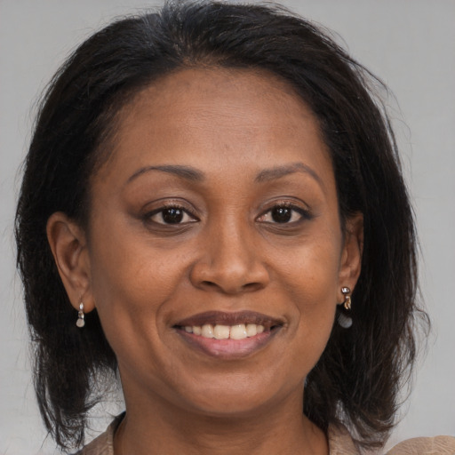Joyful black adult female with medium  brown hair and brown eyes