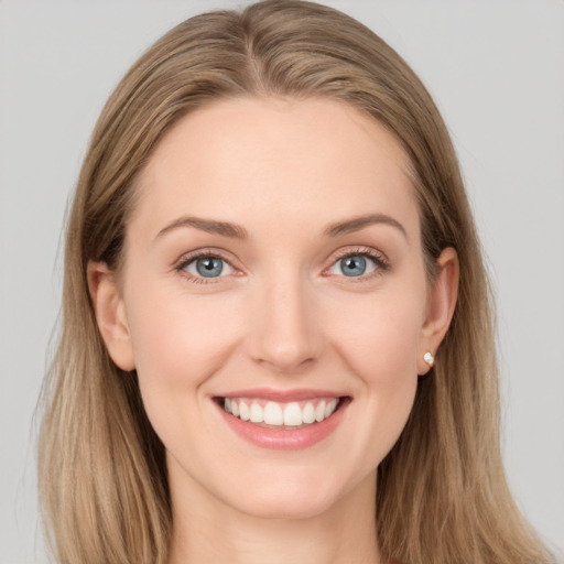 Joyful white young-adult female with long  brown hair and grey eyes