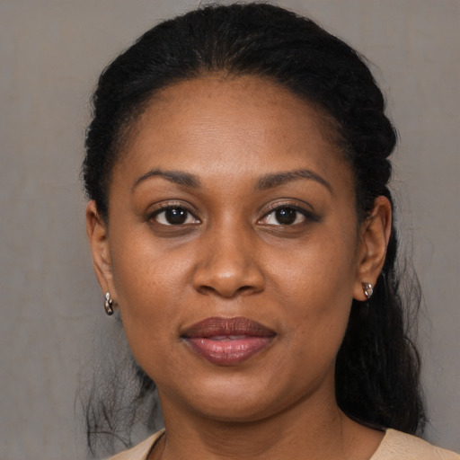Joyful black adult female with medium  black hair and brown eyes