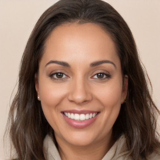 Joyful white young-adult female with long  brown hair and brown eyes