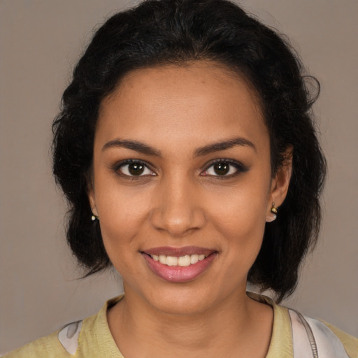 Joyful latino young-adult female with medium  brown hair and brown eyes