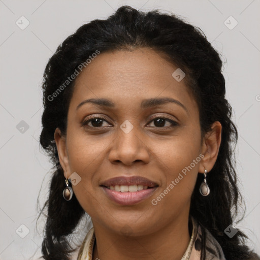 Joyful black young-adult female with long  brown hair and brown eyes