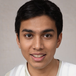 Joyful white young-adult male with short  black hair and brown eyes