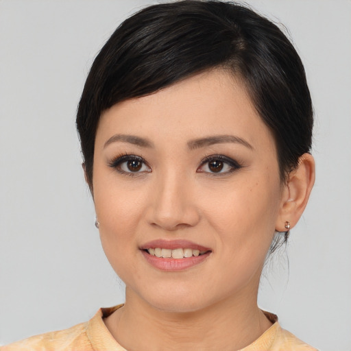 Joyful white young-adult female with medium  black hair and brown eyes