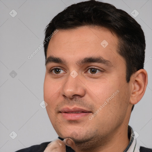 Joyful white young-adult male with short  black hair and brown eyes