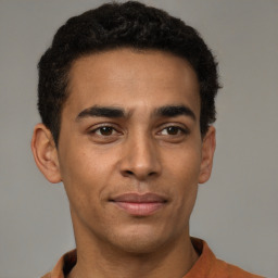 Joyful latino young-adult male with short  brown hair and brown eyes