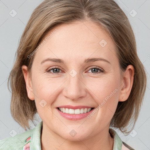 Joyful white adult female with medium  brown hair and grey eyes