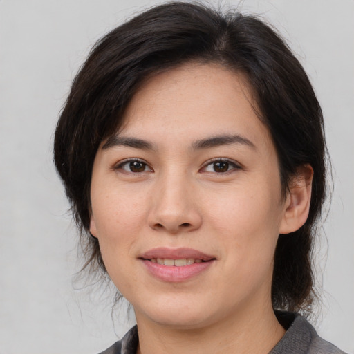 Joyful white young-adult female with medium  brown hair and brown eyes