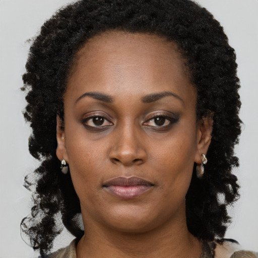 Neutral black young-adult female with long  brown hair and brown eyes