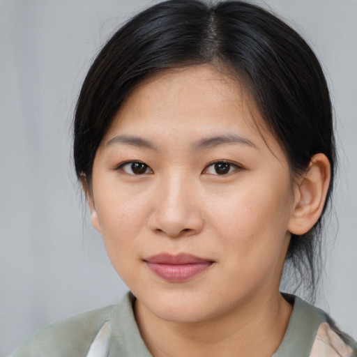 Joyful asian young-adult female with medium  brown hair and brown eyes