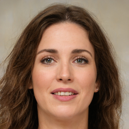 Joyful white young-adult female with long  brown hair and green eyes