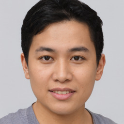 Joyful asian young-adult male with short  brown hair and brown eyes