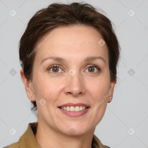 Joyful white adult female with medium  brown hair and grey eyes