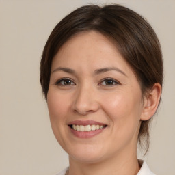 Joyful white young-adult female with medium  brown hair and brown eyes