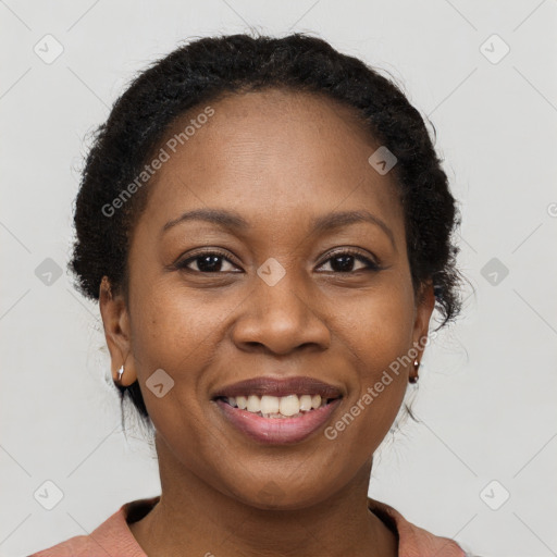 Joyful black young-adult female with short  brown hair and brown eyes