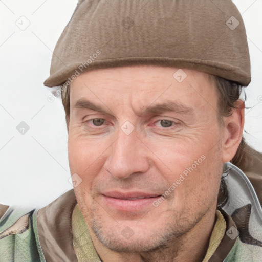 Joyful white adult male with short  brown hair and grey eyes