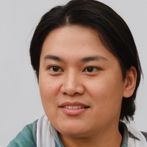 Joyful asian young-adult female with medium  brown hair and brown eyes