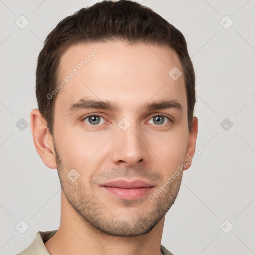 Joyful white young-adult male with short  brown hair and grey eyes