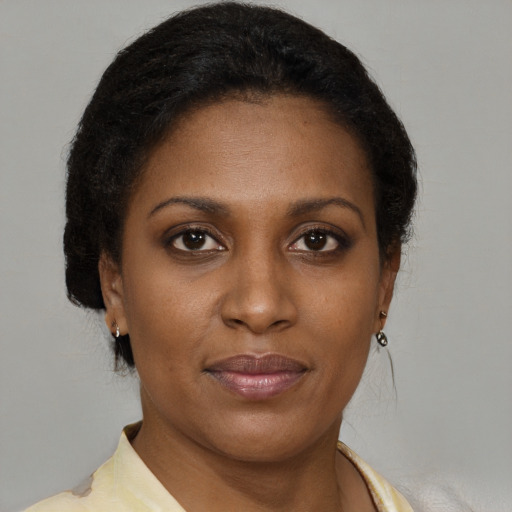 Joyful black young-adult female with short  brown hair and brown eyes