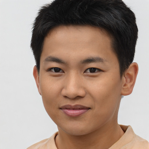 Joyful asian young-adult male with short  brown hair and brown eyes