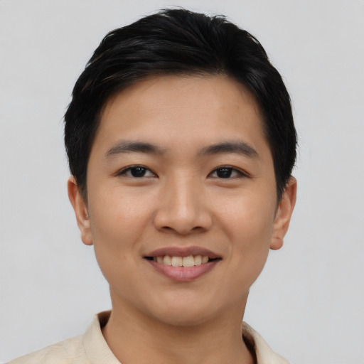 Joyful asian young-adult male with short  black hair and brown eyes