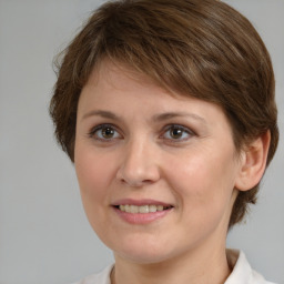 Joyful white adult female with medium  brown hair and brown eyes