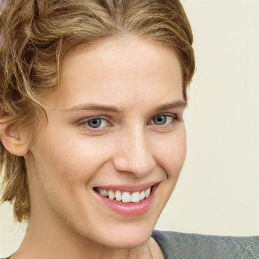 Joyful white young-adult female with short  brown hair and green eyes