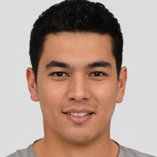 Joyful latino young-adult male with short  black hair and brown eyes