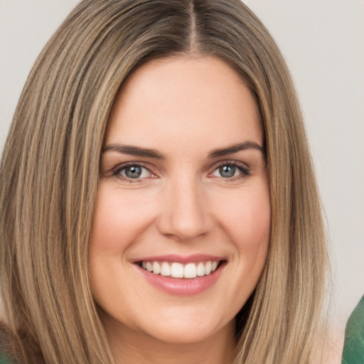 Joyful white young-adult female with long  brown hair and green eyes