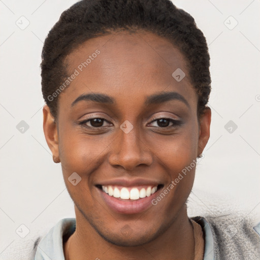 Joyful black young-adult female with short  brown hair and brown eyes