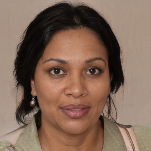 Joyful black adult female with medium  brown hair and brown eyes