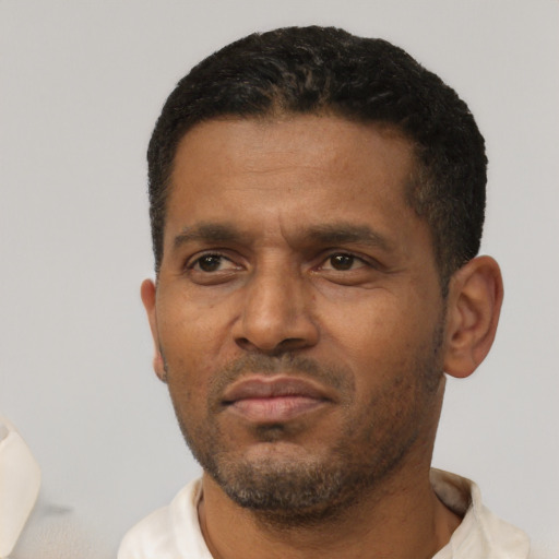 Neutral latino adult male with short  black hair and brown eyes