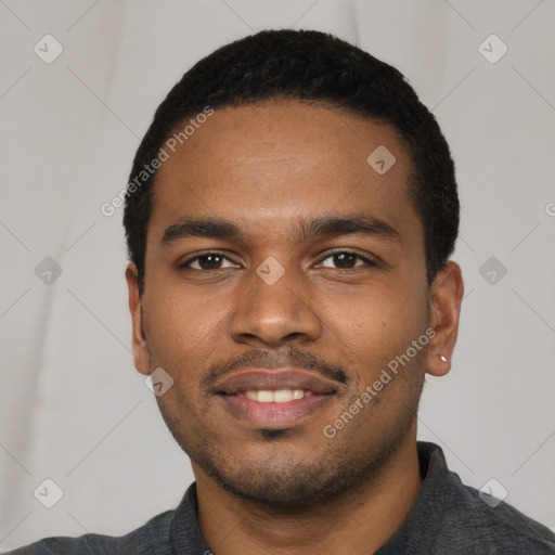Joyful black young-adult male with short  black hair and brown eyes