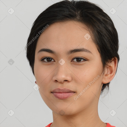 Joyful asian young-adult female with medium  black hair and brown eyes