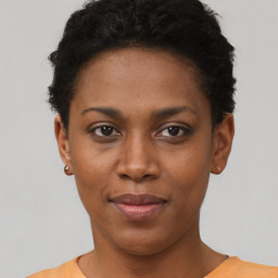 Joyful black young-adult female with short  brown hair and brown eyes