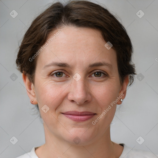 Joyful white adult female with short  brown hair and grey eyes