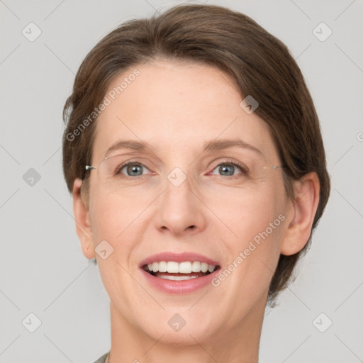 Joyful white adult female with medium  brown hair and grey eyes