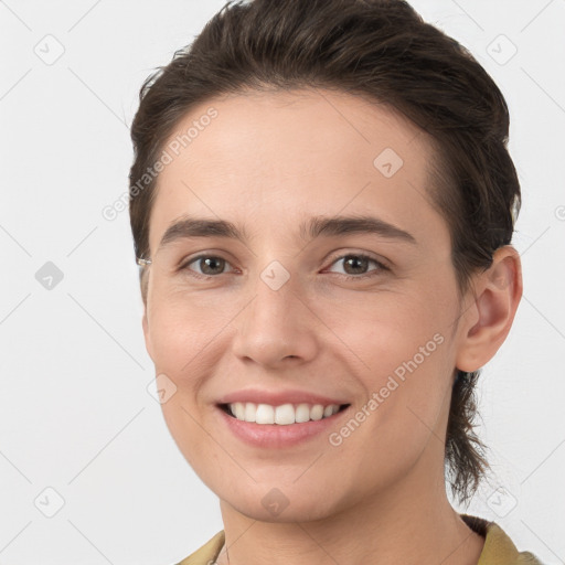 Joyful white young-adult female with short  brown hair and grey eyes