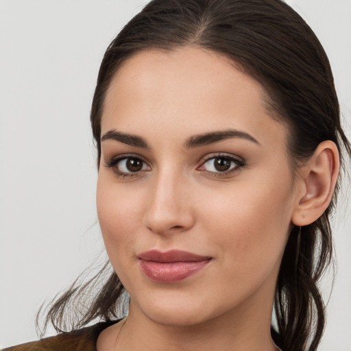 Joyful white young-adult female with long  brown hair and brown eyes